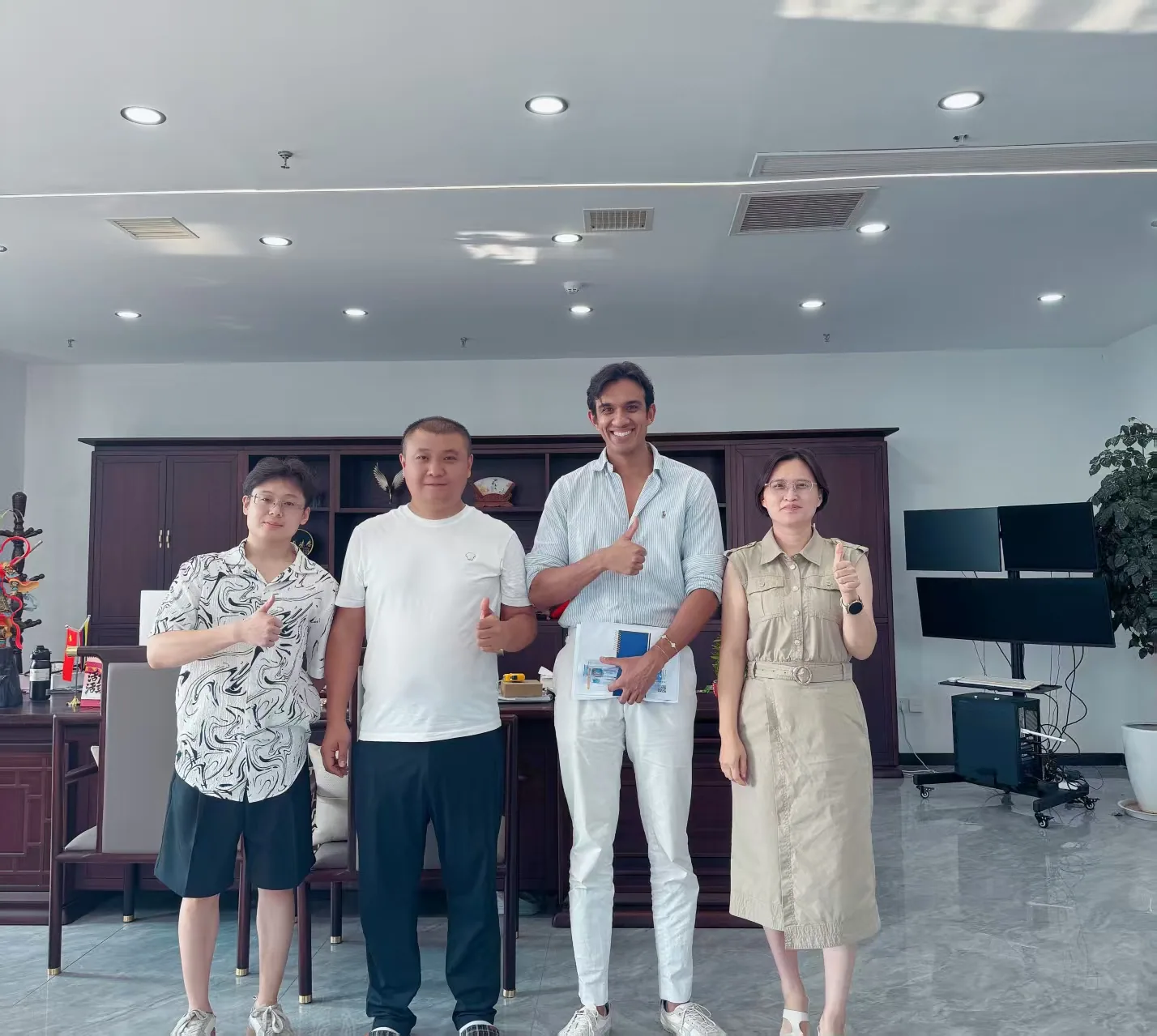 Four people standing together during a visit