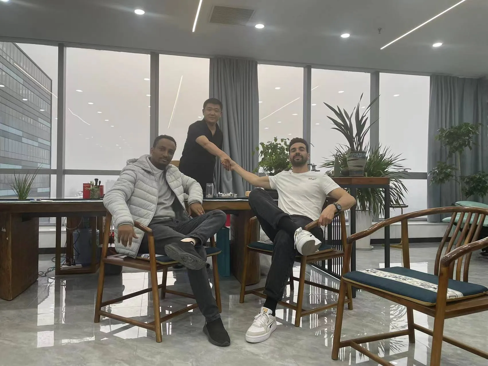 People posing together in an indoor seating area