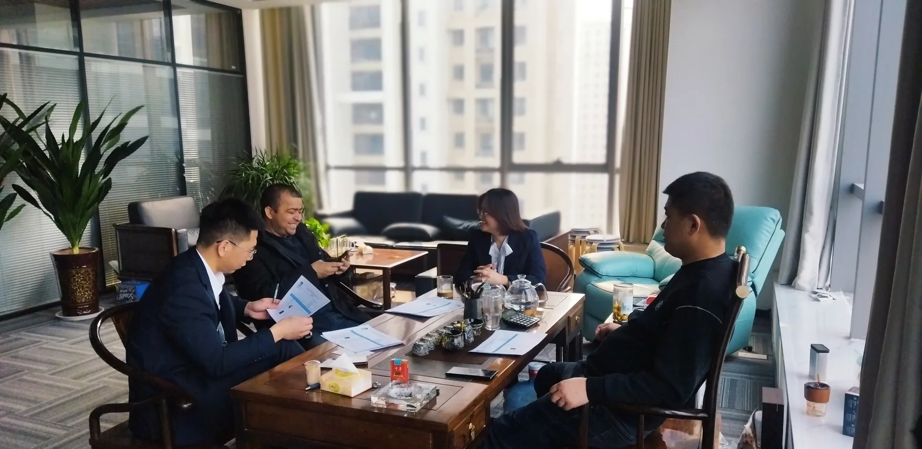 People discussing documents around a meeting table
