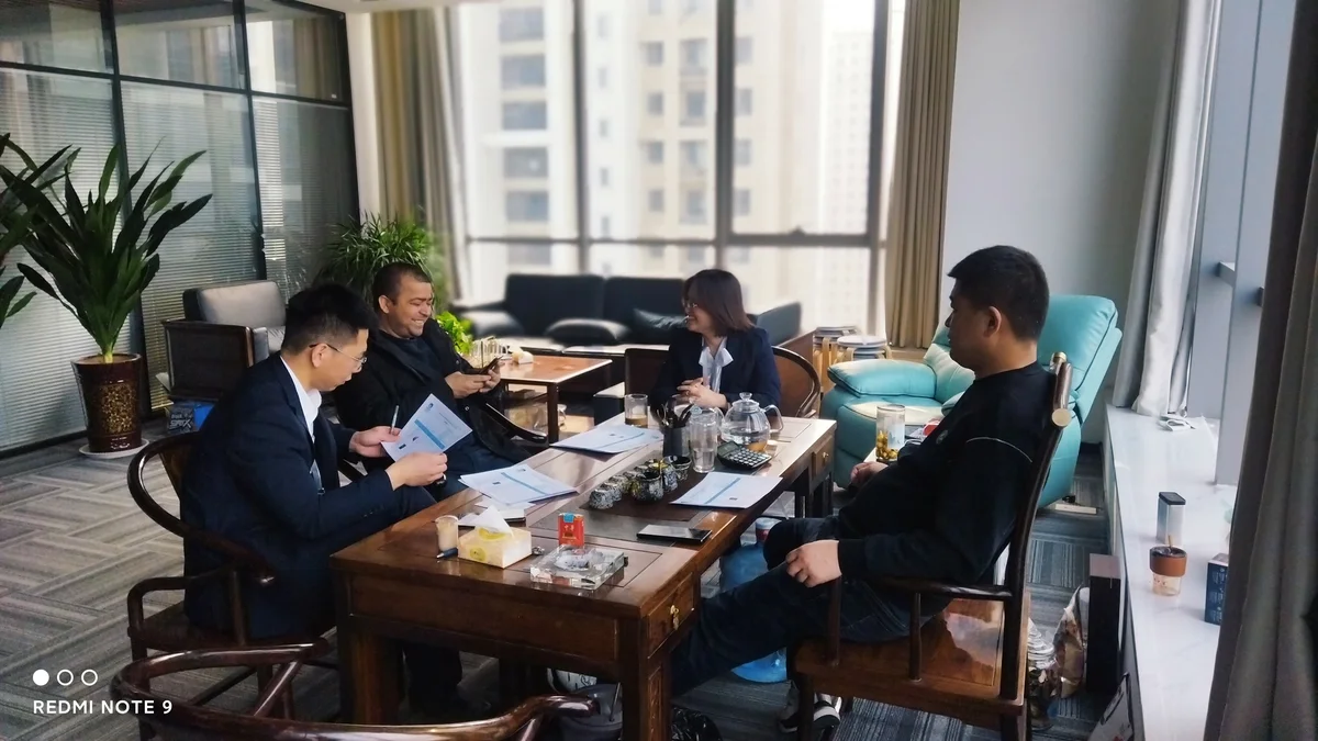 People seated around a table during a meeting