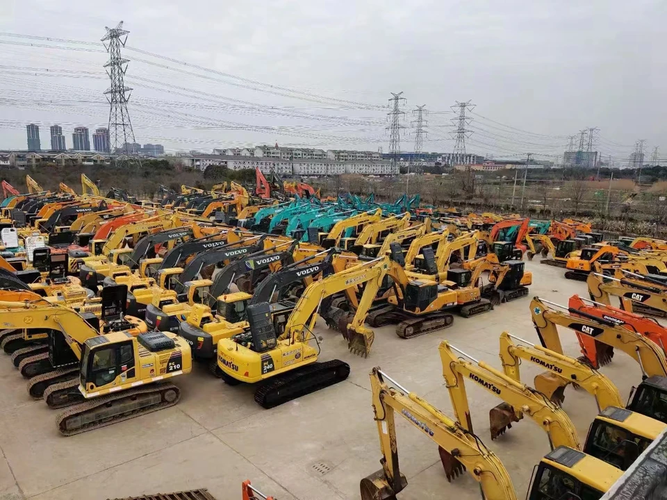 Elevated view of rows of excavators from multiple brands at an equipment yard